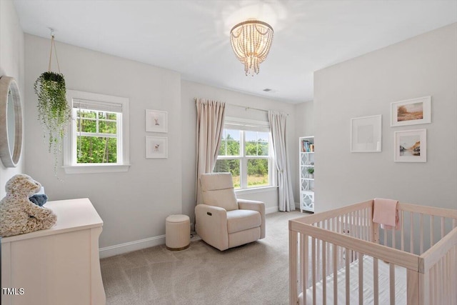 74 Permit Ct, Chapel Hill, NC 27517 - bedroom with a crib, light carpet, a chandelier, and baseboards