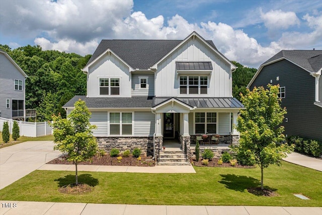 74 Permit Ct, Chapel Hill, NC 27517 - view of front of property featuring covered porch, board and batten siding, a standing seam roof, driveway, and stone siding