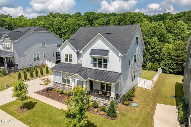 74 Permit Ct, Chapel Hill, NC 27517 - view of front facade with covered porch, a standing seam roof, driveway, board and batten siding, and roof with shingles
