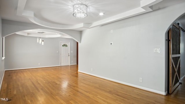 5820 Wake Forest Highway, Durham, NC 27703 - empty room with arched walkways, a raised ceiling, light wood-type flooring, and baseboards