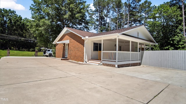 5820 Wake Forest Highway, Durham, NC 27703 - view of front of property featuring covered porch, brick siding, driveway, and a shingled roof