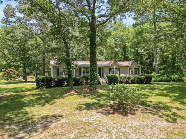 21621 Old Maxton Rd, Maxton, NC 28364 - view of front of property featuring a front yard, a porch, and metal roof
