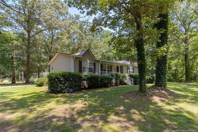 21621 Old Maxton Rd, Maxton, NC 28364 - view of side of home featuring a yard and covered porch