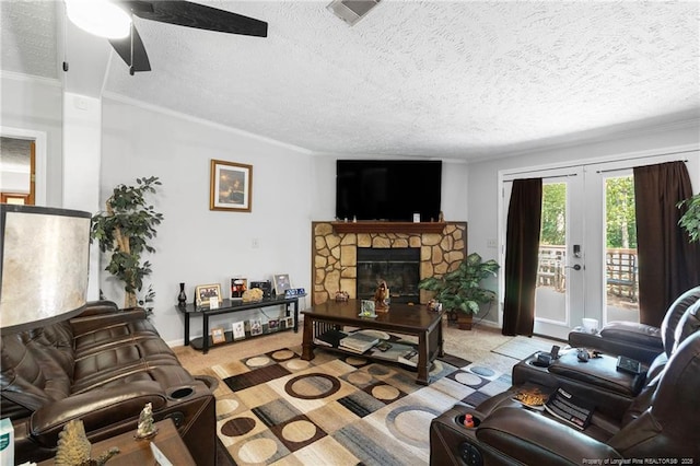 21621 Old Maxton Rd, Maxton, NC 28364 - living room featuring a textured ceiling, a ceiling fan, ornamental molding, a fireplace, and baseboards