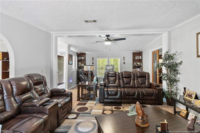 21621 Old Maxton Rd, Maxton, NC 28364 - living room with a textured ceiling, ceiling fan, arched walkways, ornamental molding, and light carpet