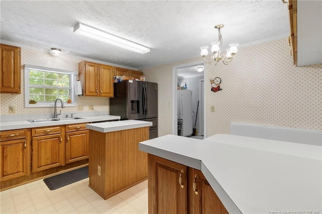 21621 Old Maxton Rd, Maxton, NC 28364 - kitchen featuring a sink, fridge with ice dispenser, refrigerator, wallpapered walls, and light countertops