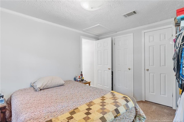 21621 Old Maxton Rd, Maxton, NC 28364 - bedroom featuring attic access, a textured ceiling, ornamental molding, and light carpet