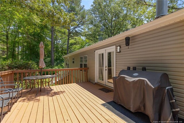 21621 Old Maxton Rd, Maxton, NC 28364 - wooden terrace featuring french doors, grilling area, and outdoor dining area