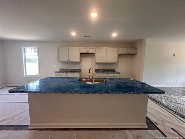 112 Dalton Dr, Lumber Bridge, NC 28357 - kitchen featuring a sink, an island with sink, dark stone counters, baseboards, and recessed lighting