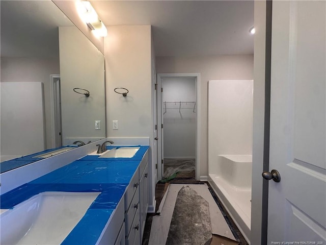 112 Dalton Dr, Lumber Bridge, NC 28357 - bathroom featuring double vanity and a spacious closet