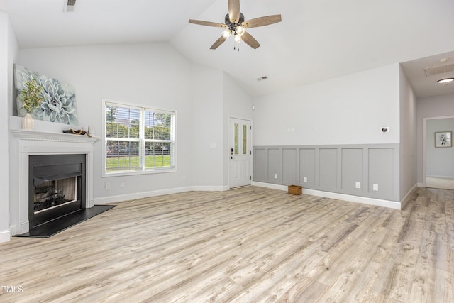 2761 Andover Glen Rd, Raleigh, NC 27604 - unfurnished living room with high vaulted ceiling, wood finished floors, a fireplace with raised hearth, and ceiling fan