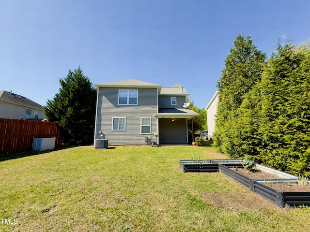 1104 Pebblestone Dr, Durham, NC 27703 - rear view of house featuring a vegetable garden and central AC unit