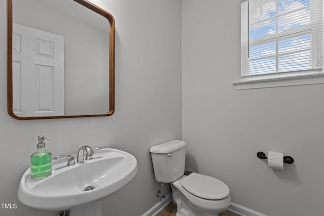 1104 Pebblestone Dr, Durham, NC 27703 - bathroom featuring a sink, baseboards, and toilet