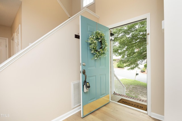 105 Old Dock Trl, Cary, NC 27519 - foyer featuring wood finished floors, healthy amount of natural light, a towering ceiling, and baseboards
