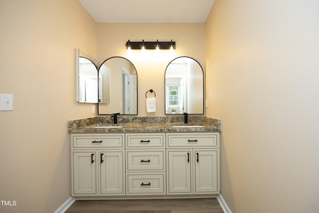 105 Old Dock Trl, Cary, NC 27519 - bathroom featuring wood finished floors, double vanity, and baseboards