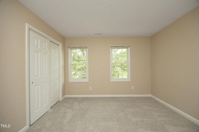 105 Old Dock Trl, Cary, NC 27519 - unfurnished bedroom with light carpet, baseboards, a textured ceiling, and a closet