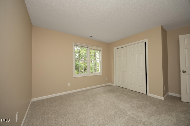 105 Old Dock Trl, Cary, NC 27519 - unfurnished bedroom featuring carpet, baseboards, a closet, and a textured ceiling