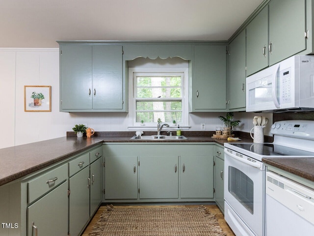 114 Brenrose Cir, Durham, NC 27705 - kitchen with white appliances, a sink, dark countertops, and wood finished floors