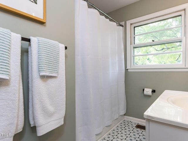 114 Brenrose Cir, Durham, NC 27705 - full bath featuring baseboards, vanity, a shower with shower curtain, and tile patterned floors