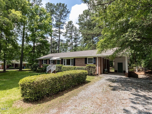 114 Brenrose Cir, Durham, NC 27705 - ranch-style house with driveway, brick siding, a front lawn, and an attached carport
