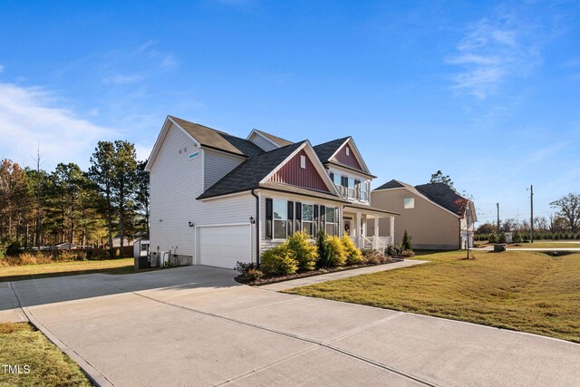 46 Two Belles Ct, Angier, NC 27501 - view of front facade featuring concrete driveway, a front yard, an attached garage, roof with shingles, and board and batten siding