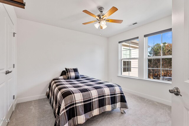 46 Two Belles Ct, Angier, NC 27501 - carpeted bedroom with baseboards and ceiling fan