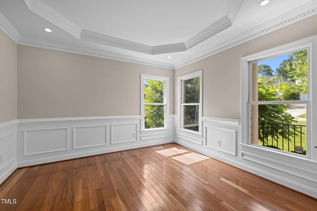 7409 Chesley Ln, Durham, NC 27713 - unfurnished room with wood finished floors, a wainscoted wall, crown molding, a raised ceiling, and recessed lighting