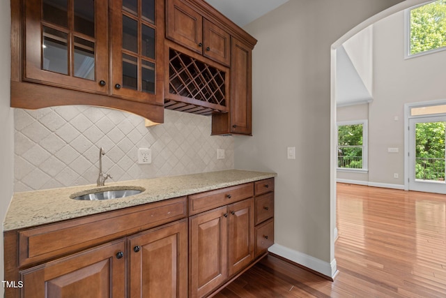 7409 Chesley Ln, Durham, NC 27713 - kitchen with a sink, dark wood finished floors, backsplash, and baseboards