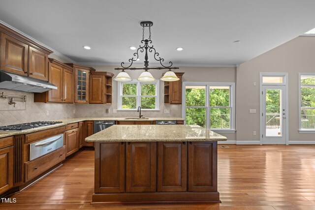 7409 Chesley Ln, Durham, NC 27713 - kitchen with under cabinet range hood, a warming drawer, open shelves, a sink, and a kitchen island