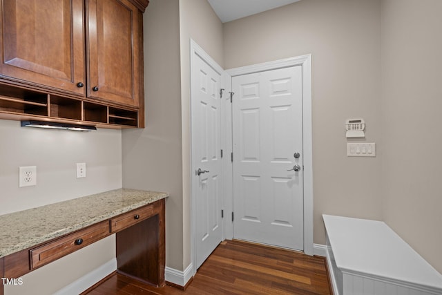 7409 Chesley Ln, Durham, NC 27713 - mudroom with dark wood-style flooring, built in study area, and baseboards