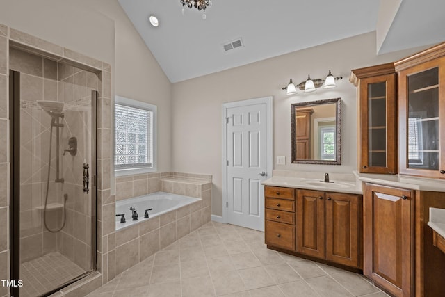 7409 Chesley Ln, Durham, NC 27713 - full bathroom with vanity, a bath, lofted ceiling, a shower stall, and healthy amount of natural light