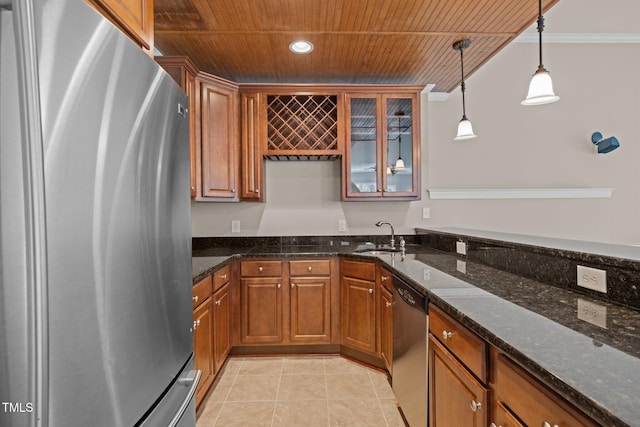 7409 Chesley Ln, Durham, NC 27713 - kitchen featuring appliances with stainless steel finishes, wood ceiling, a sink, brown cabinets, and pendant lighting