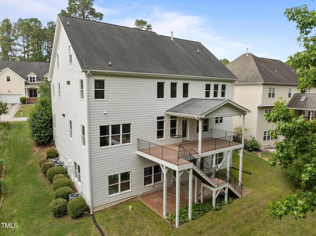 7409 Chesley Ln, Durham, NC 27713 - back of house featuring a yard, stairs, and roof with shingles