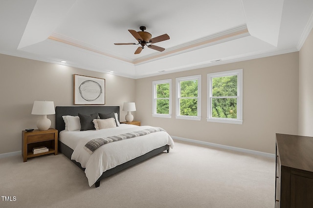 7409 Chesley Ln, Durham, NC 27713 - bedroom featuring a tray ceiling, light carpet, crown molding, and ceiling fan
