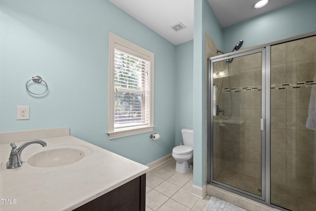 12216 Kyle Abbey Ln, Raleigh, NC 27613 - full bathroom with vanity, tile patterned flooring, toilet, a shower stall, and baseboards