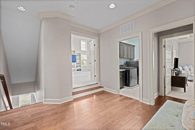 12216 Kyle Abbey Ln, Raleigh, NC 27613 - foyer featuring washer and dryer, baseboards, wood finished floors, ornamental molding, and recessed lighting
