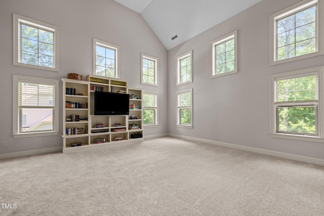 12216 Kyle Abbey Ln, Raleigh, NC 27613 - unfurnished living room featuring baseboards, high vaulted ceiling, and carpet flooring
