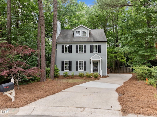 15 Gray Fox Ct, Durham, NC 27713 - colonial-style house featuring driveway, a chimney, and a shingled roof