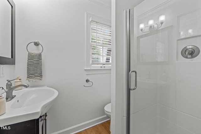 15 Gray Fox Ct, Durham, NC 27713 - bathroom with a shower stall, wood finished floors, toilet, baseboards, and ornamental molding