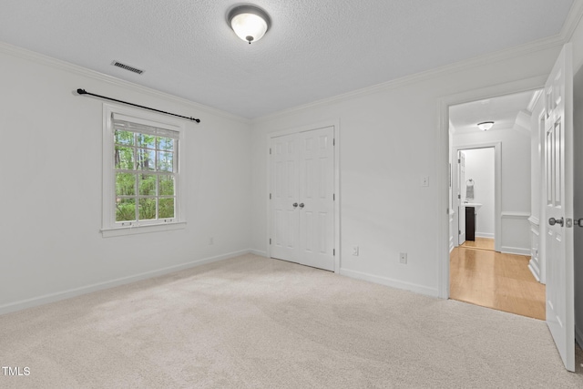15 Gray Fox Ct, Durham, NC 27713 - unfurnished bedroom with carpet, ornamental molding, a textured ceiling, a closet, and baseboards