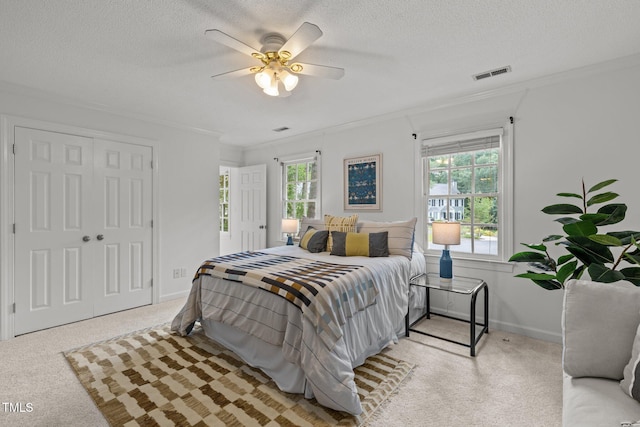 15 Gray Fox Ct, Durham, NC 27713 - bedroom with carpet floors, multiple windows, crown molding, a textured ceiling, and ceiling fan