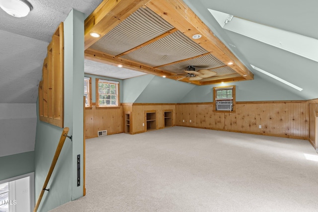 15 Gray Fox Ct, Durham, NC 27713 - additional living space with wooden walls, lofted ceiling, ceiling fan, cooling unit, and carpet