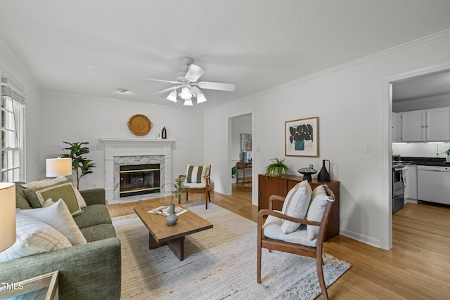 15 Gray Fox Ct, Durham, NC 27713 - living area featuring a high end fireplace, light wood-type flooring, a ceiling fan, ornamental molding, and baseboards