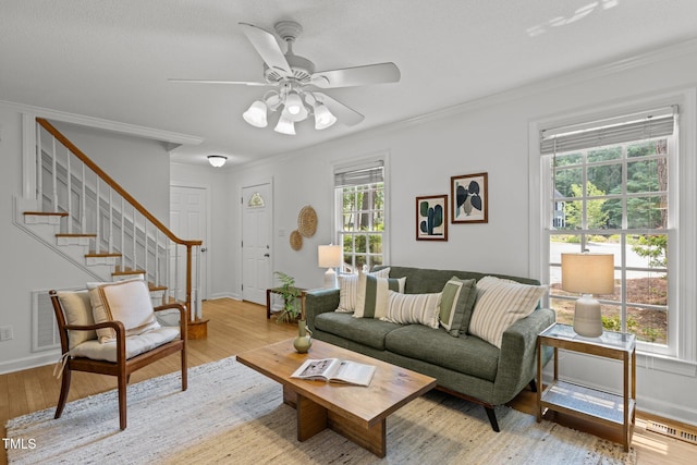 15 Gray Fox Ct, Durham, NC 27713 - living area with light wood-type flooring, crown molding, a ceiling fan, stairway, and baseboards