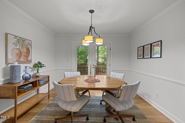 15 Gray Fox Ct, Durham, NC 27713 - dining space with light wood-style floors, french doors, a chandelier, ornamental molding, and baseboards