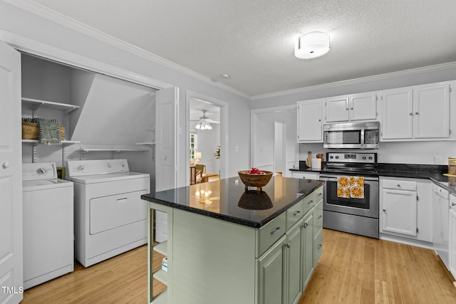 15 Gray Fox Ct, Durham, NC 27713 - kitchen with appliances with stainless steel finishes, separate washer and dryer, white cabinets, light wood-type flooring, and crown molding
