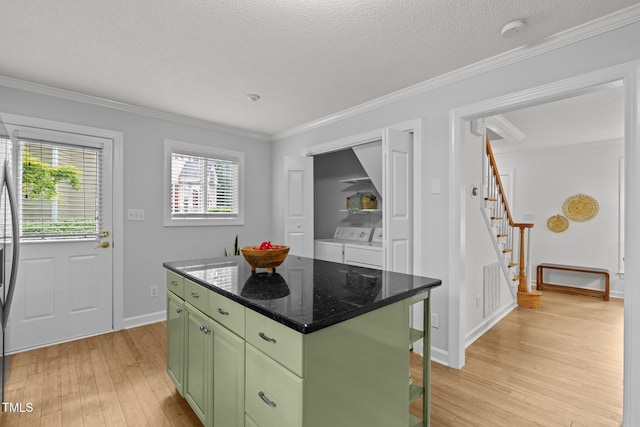 15 Gray Fox Ct, Durham, NC 27713 - kitchen featuring green cabinetry, light wood-style flooring, a center island, separate washer and dryer, and ornamental molding