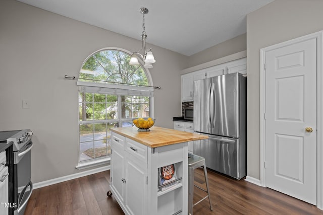 107 Covington Dr, Chapel Hill, NC 27514 - kitchen featuring appliances with stainless steel finishes, butcher block countertops, white cabinetry, and healthy amount of natural light