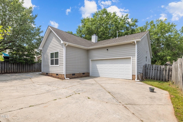 107 Covington Dr, Chapel Hill, NC 27514 - view of home's exterior featuring crawl space, concrete driveway, an attached garage, a chimney, and roof with shingles