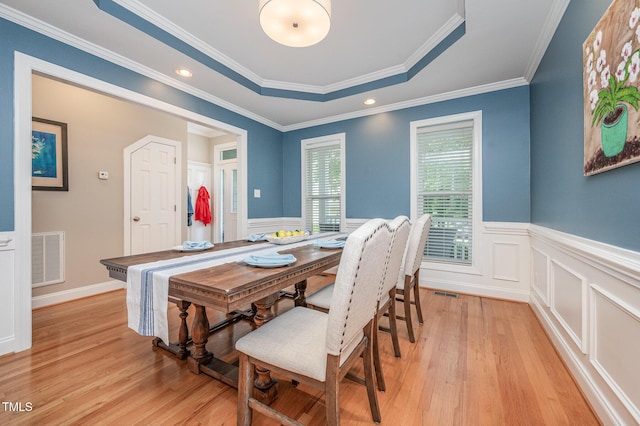 1230 Golden Bluff Ln, Fuquay Varina, NC 27526 - dining area with light wood-style floors, wainscoting, crown molding, and a raised ceiling